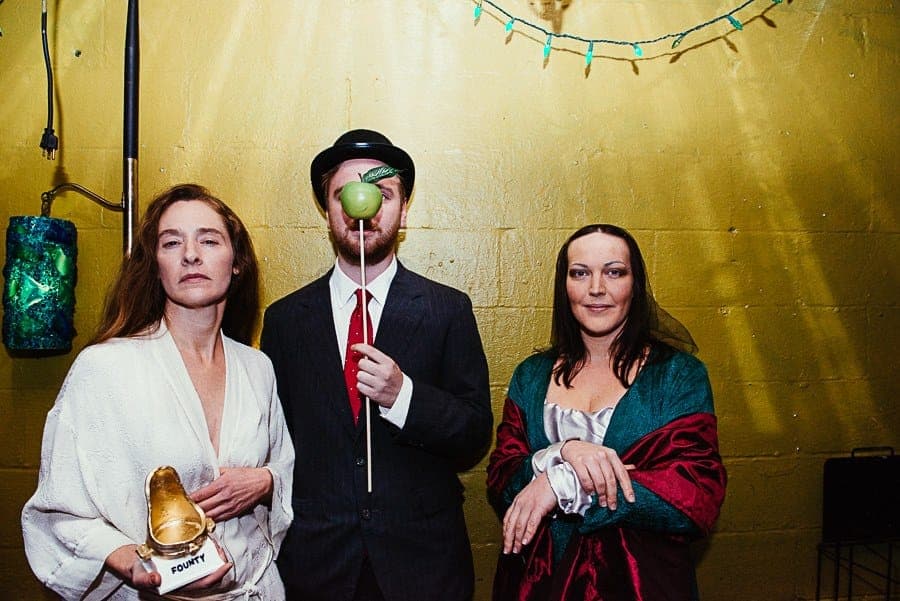 Three guests dressed as famous artworks holding gold Founty trophies
